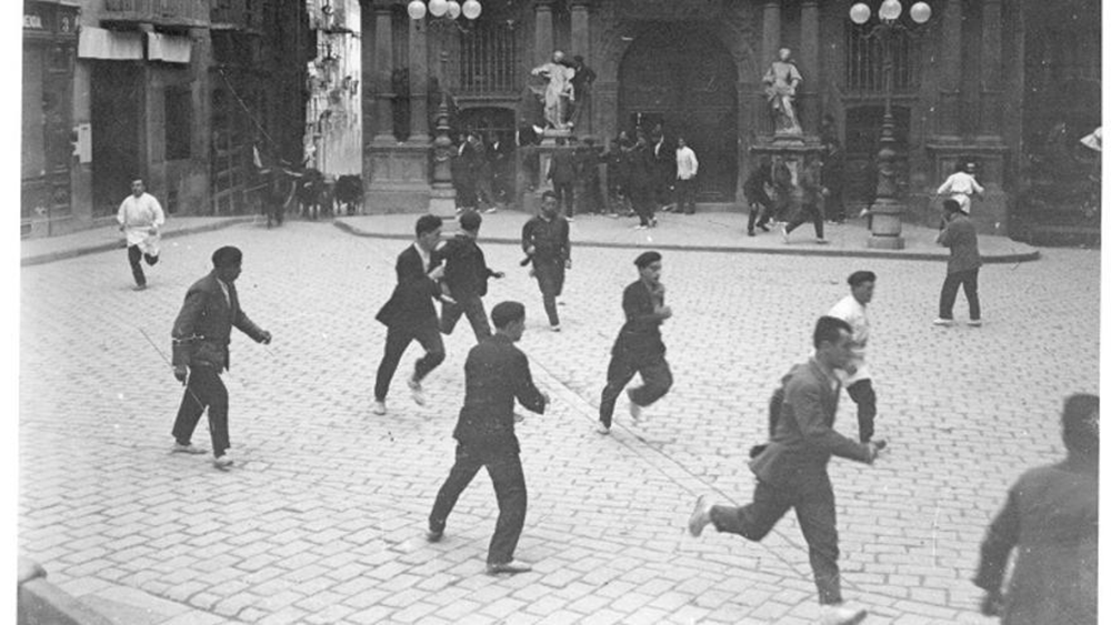 Archival image of an early Running of the Bulls scene in Pamplona
