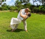 A couple shares a romantic dance in a lush garden in Mérida, Mexico, symbolizing love and happiness.